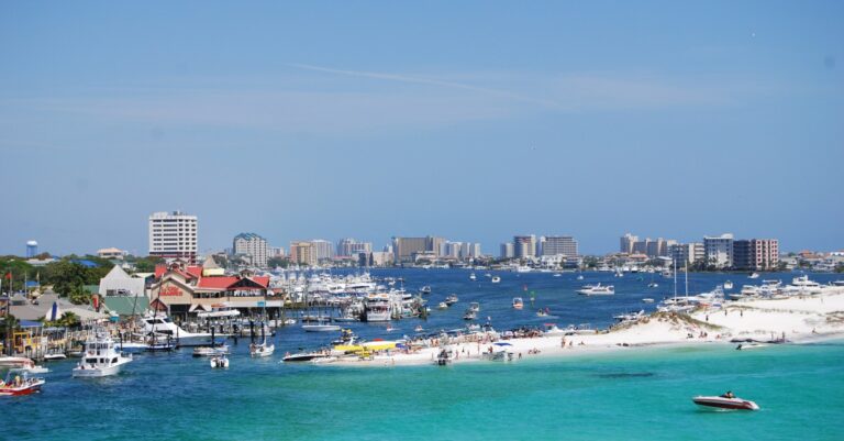 Boats in Destin Harbor with the sandy edge of Norriego Point in the foreground