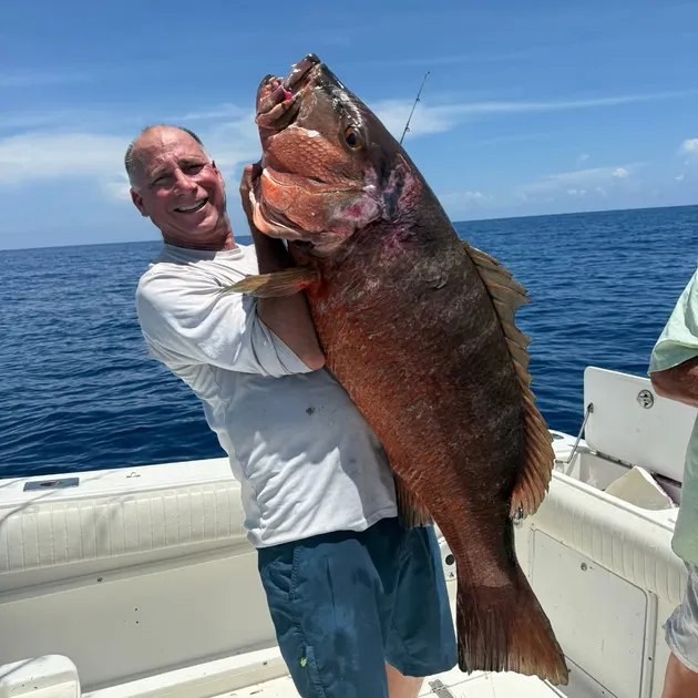 Reel Lucky Fishing Charters angler holding a grouper
