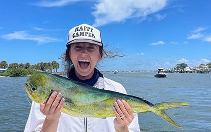 Young angler holding a mahi on a Stuart Sport Fishing trip