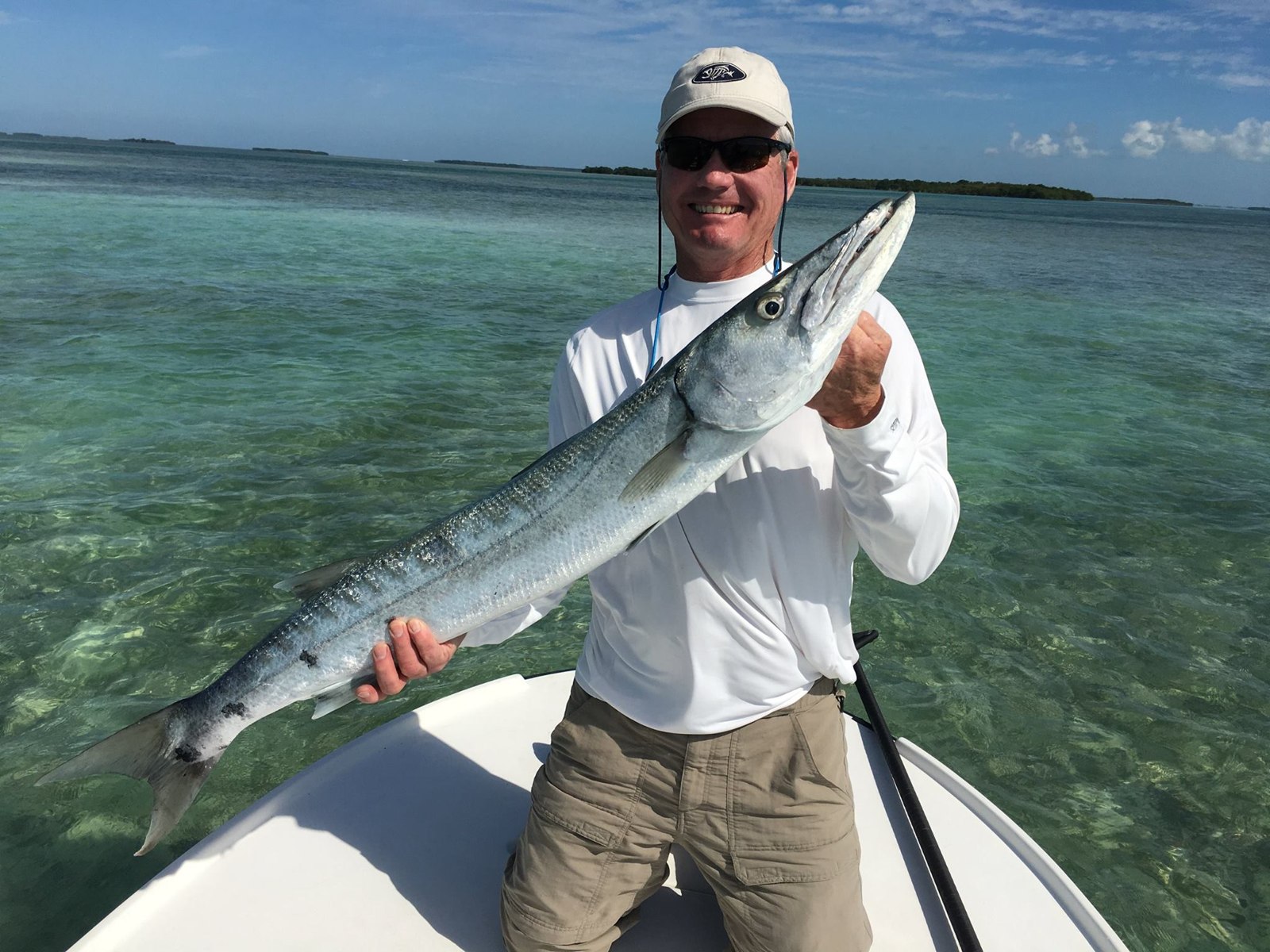 Angler displaying a barracuda with Native Charters