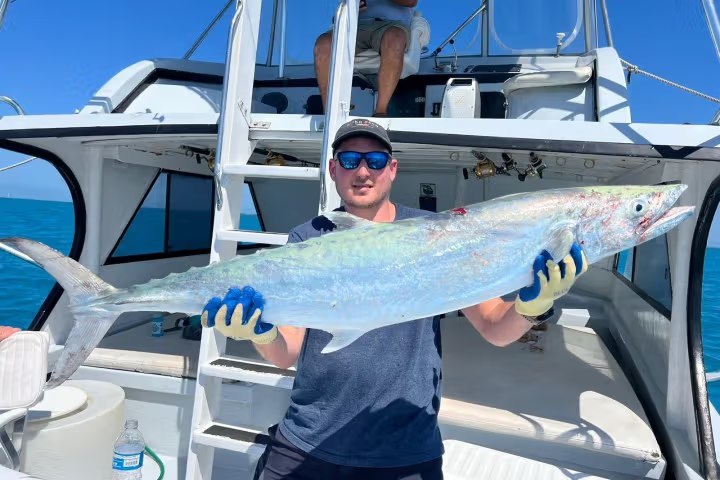 Angler displaying a colorful fish on deck with Linda D Sportfishing