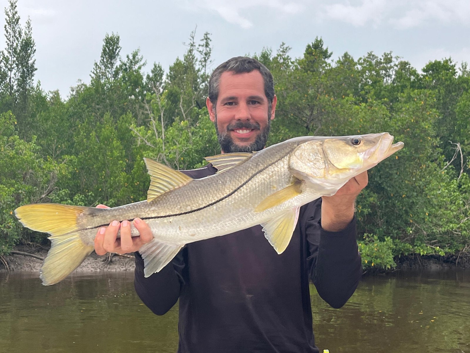 Angler displaying a snook with Plantation Island Adventures
