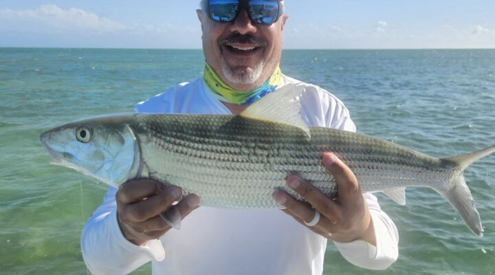 Angler holding a bonefish with Captain Tim Carlile