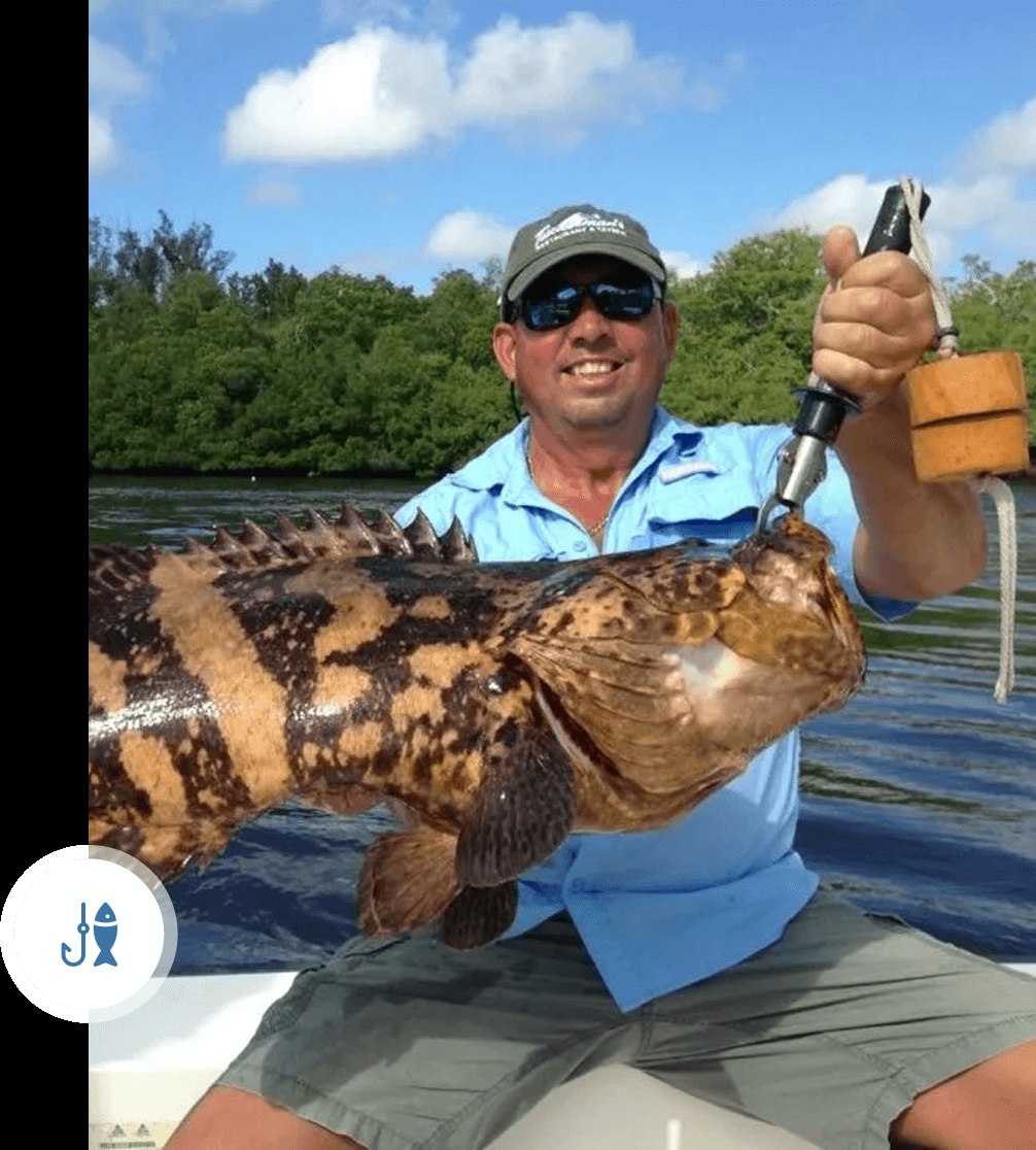 Angler holding a grouper on an Everglades Fishing Charters trip