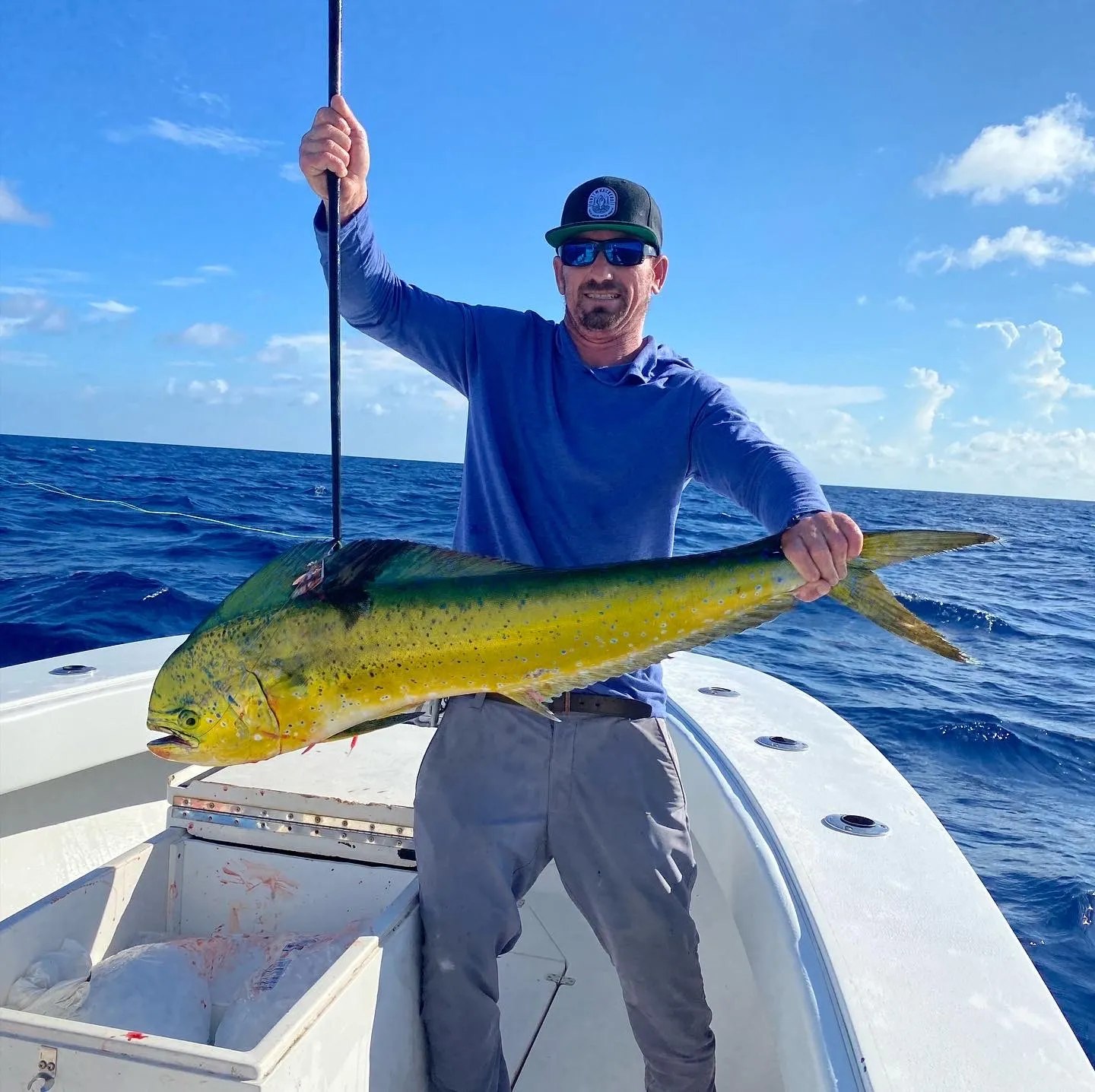 Angler holding a mahi mahi with Boa Vida Charters
