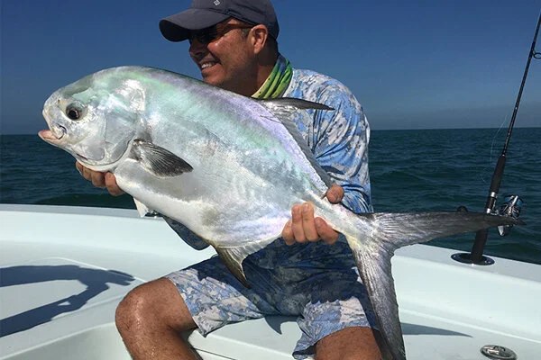 Angler holding a permit aboard Everglades Fishing Adventures