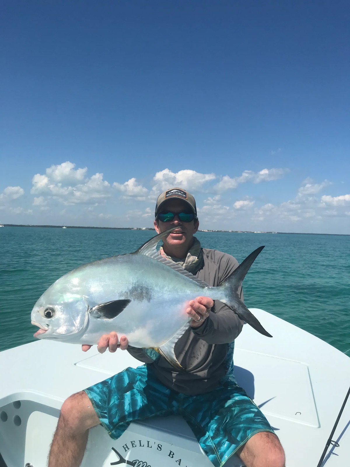 Angler holding a permit on a Flipside Charters trip