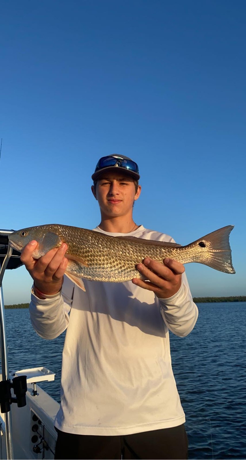 Angler holding a redfish aboard Chokoloskee Charters