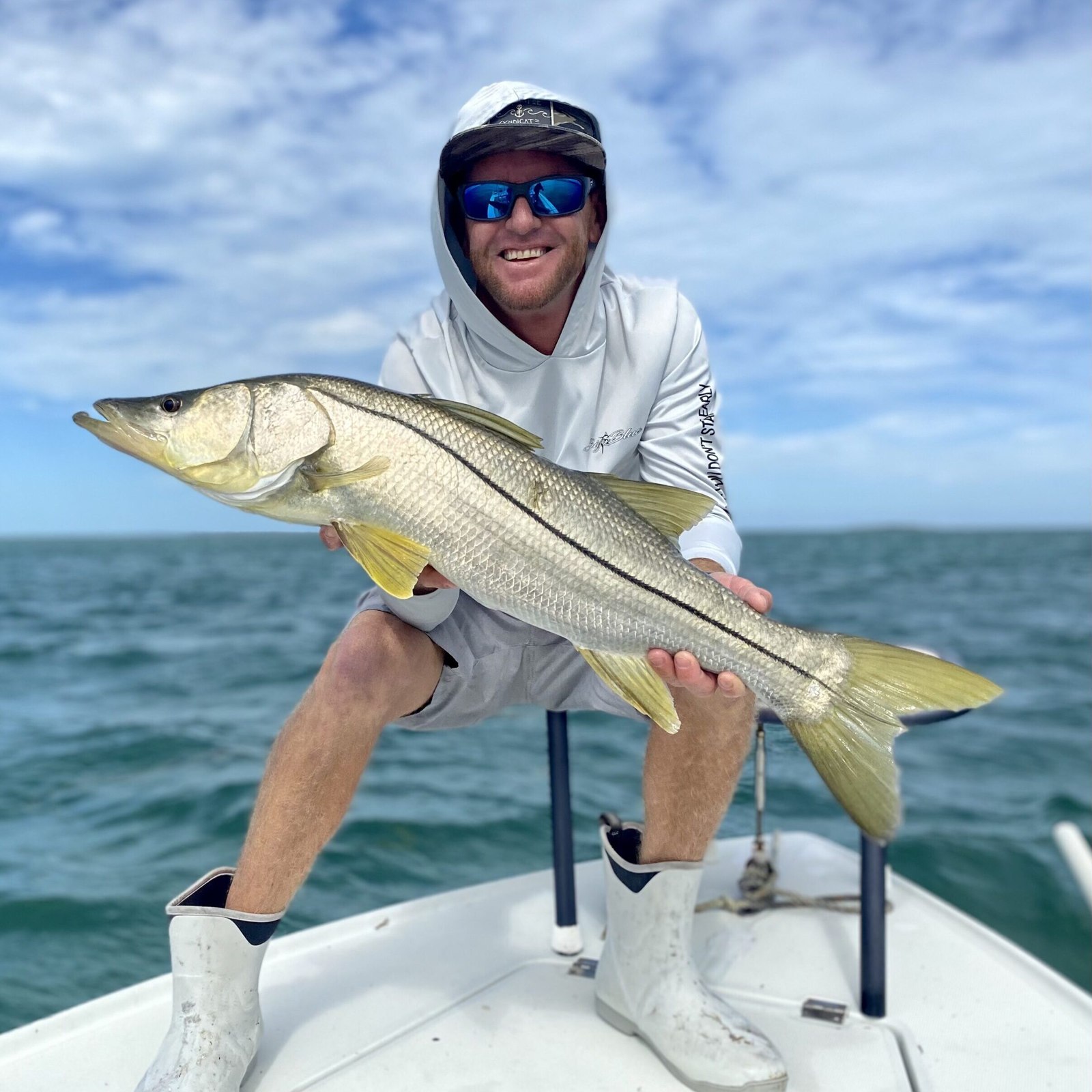 Angler holding a snook with Tight N Up Charters