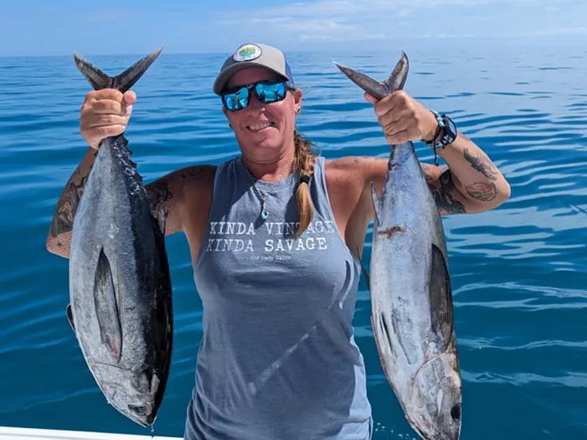 Angler holding two tuna with Salty Paradise Charters