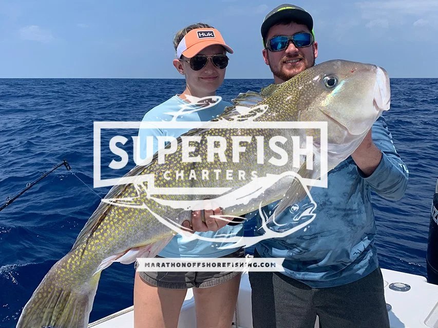 Anglers displaying a fish in a charter photo with Superfish Charters