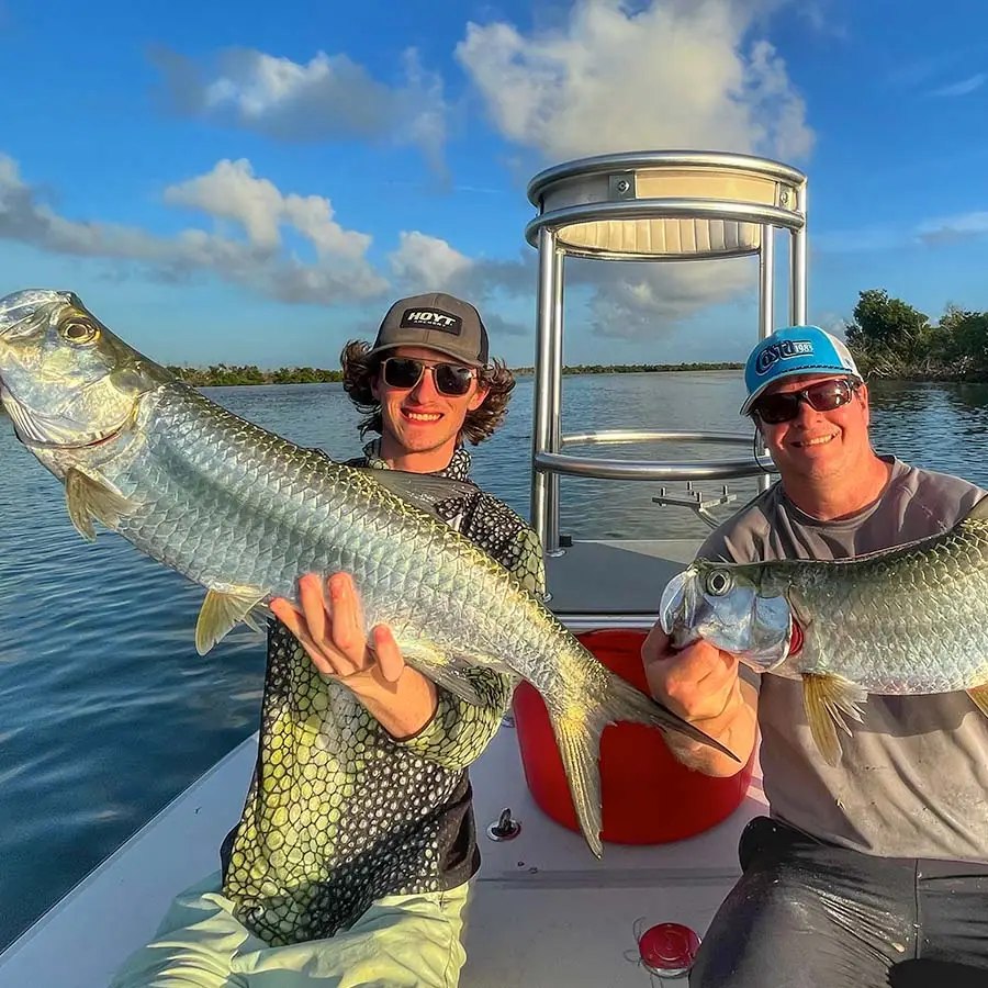 Anglers displaying a tarpon with Goliath Charters