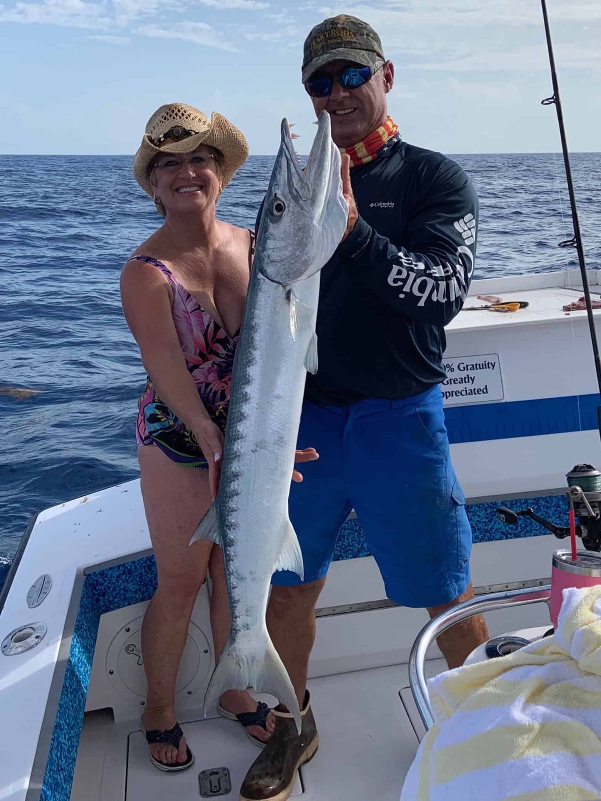 Anglers displaying a wahoo with Too Lethal Charters