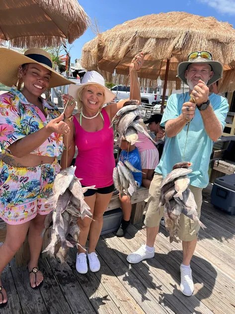 Anglers Dream Fishing group displaying catches by the waterfront