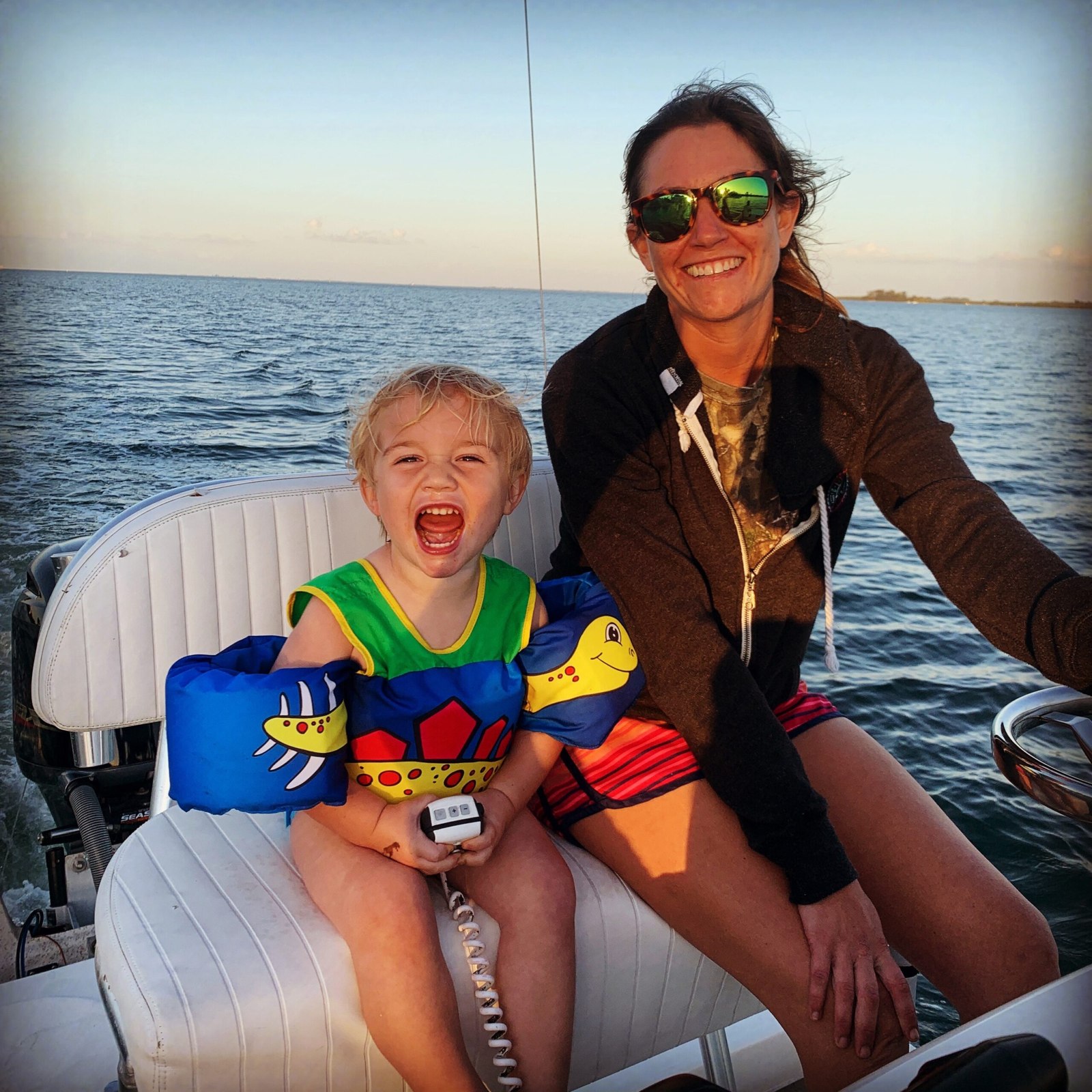 Anna Maria Charters adult and child seated aboard the boat