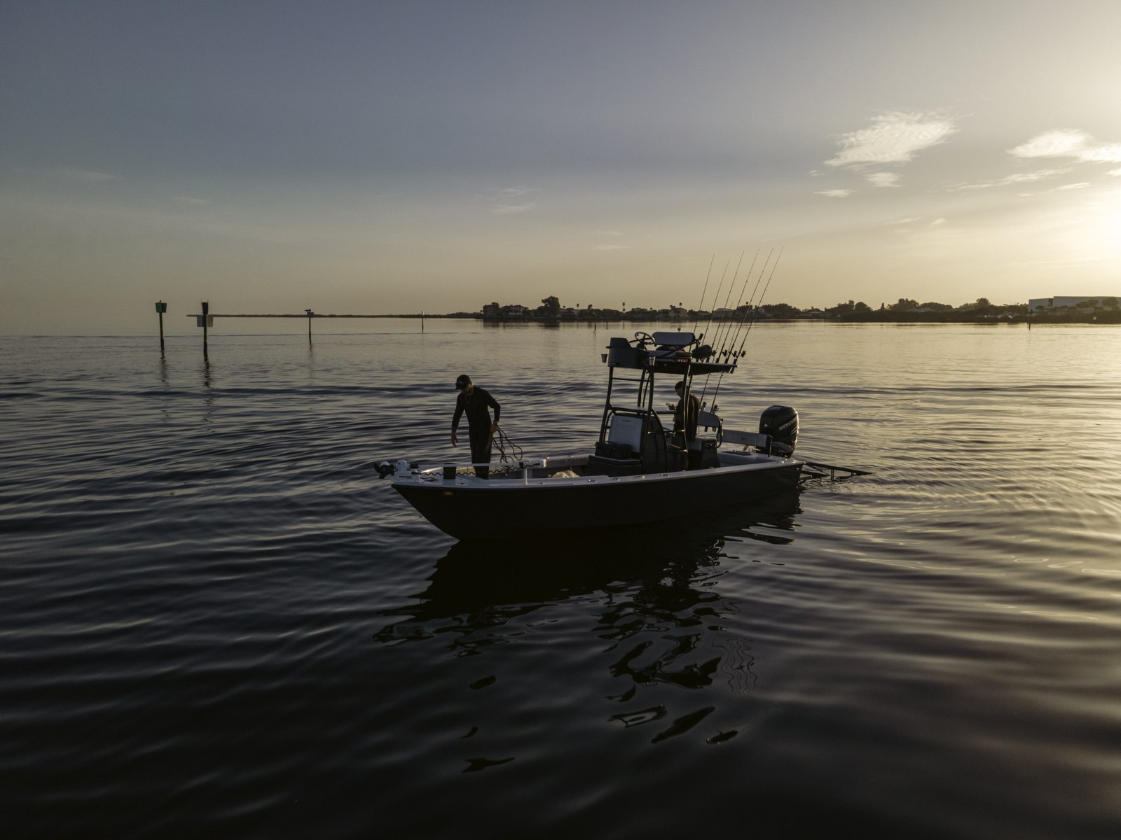Blacked Out Fishing Charters tower boat on calm water at sunset