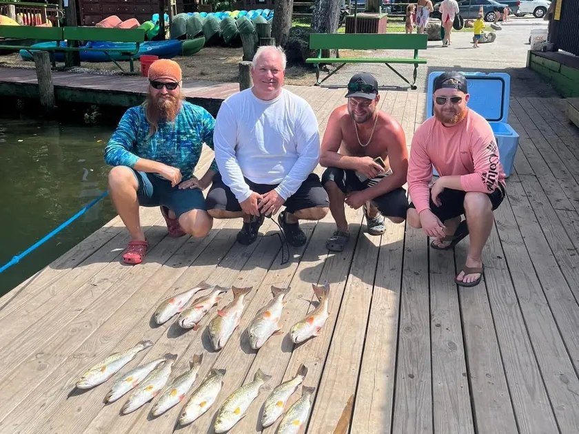 BWC Charters anglers beside their catch on a wooden dock