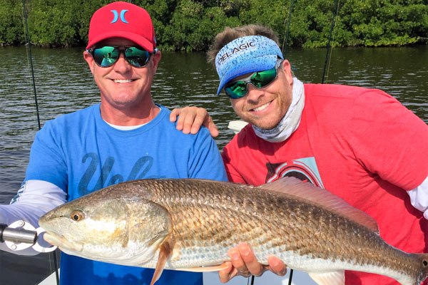 Caloosa Charters two anglers displaying redfish