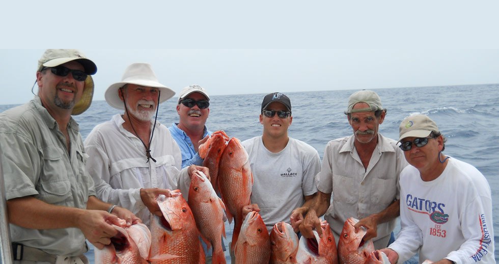 Capt. Marvel Charters group displaying snapper at the dock