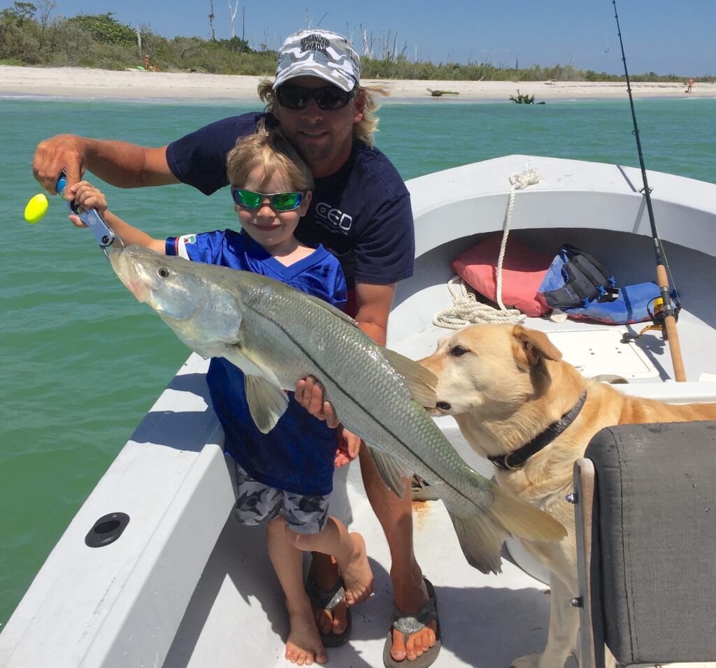 Captain Joe's Charters adult and child displaying their catch