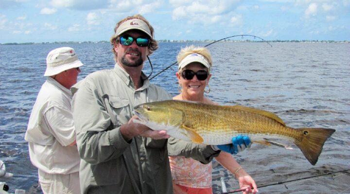 Captain Mike fishing guest holding a snook