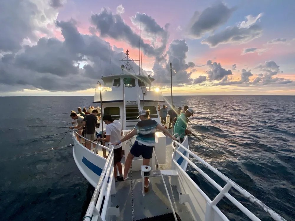 Captain Tony's Fishing Adventures view from the charter boat bow with anglers at sea