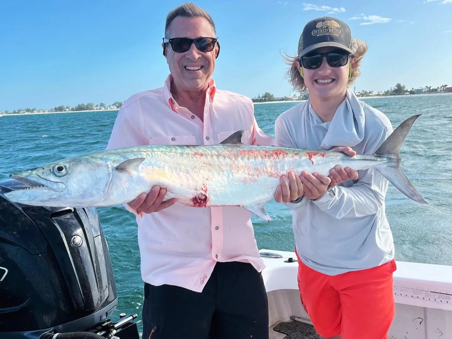 Chasing Limits Charters anglers displaying a barracuda