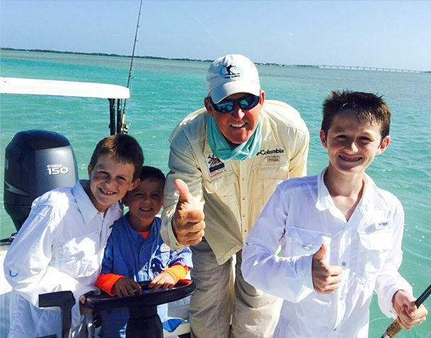 Children and their guide displaying a catch on a Captain Ted Wilson trip