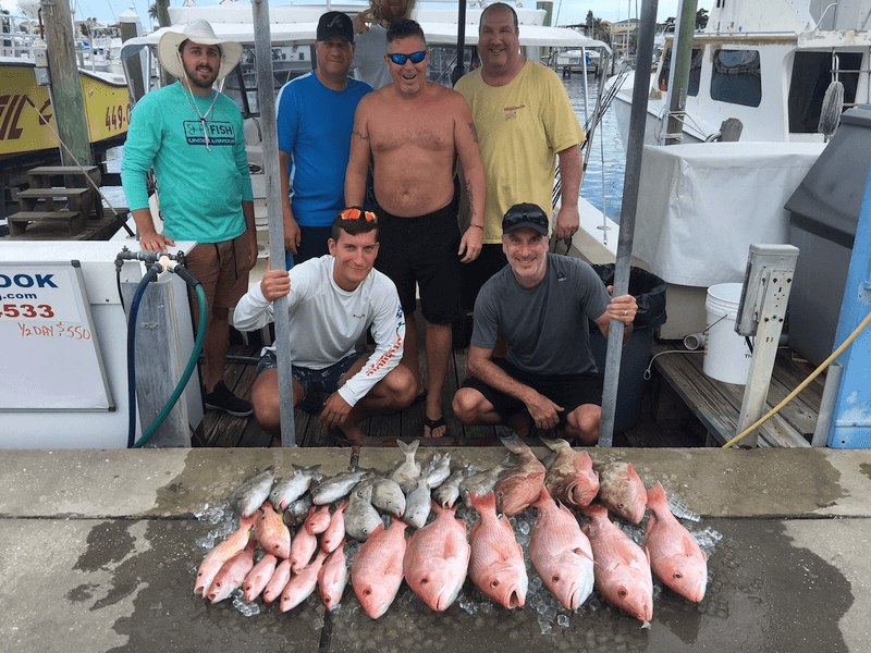 Double Hook fishing group with their catch displayed at the dock