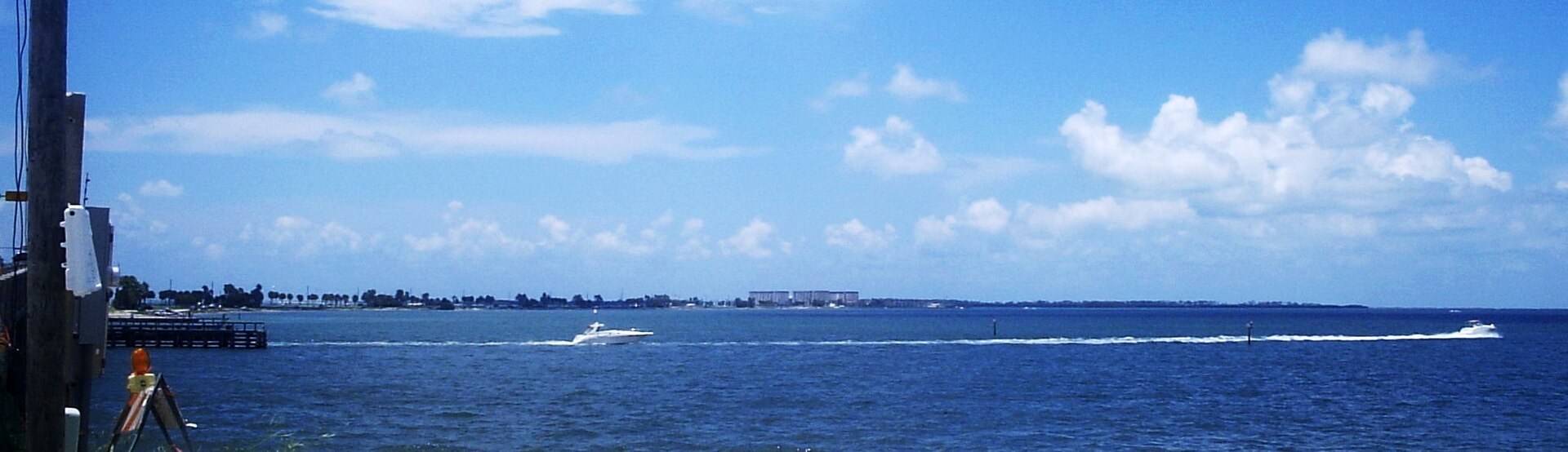 Water beside Dunedin Causeway with a boat wake and distant shoreline in 2006
