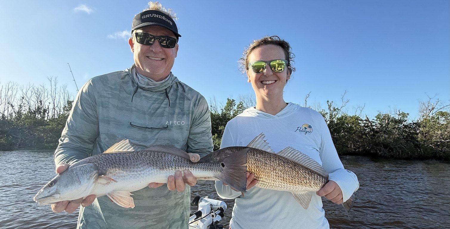 Endless Summer Charters two anglers holding redfish