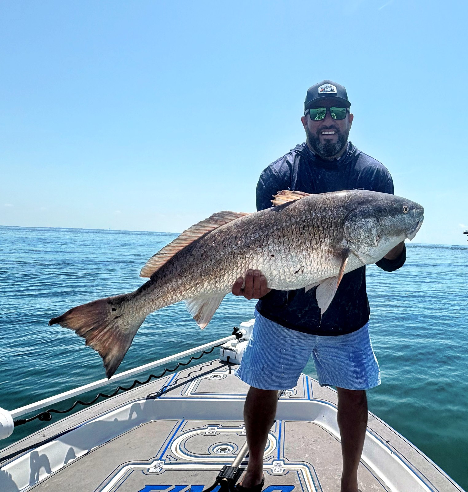 Fish Hawk Fishing Charters angler holding a redfish