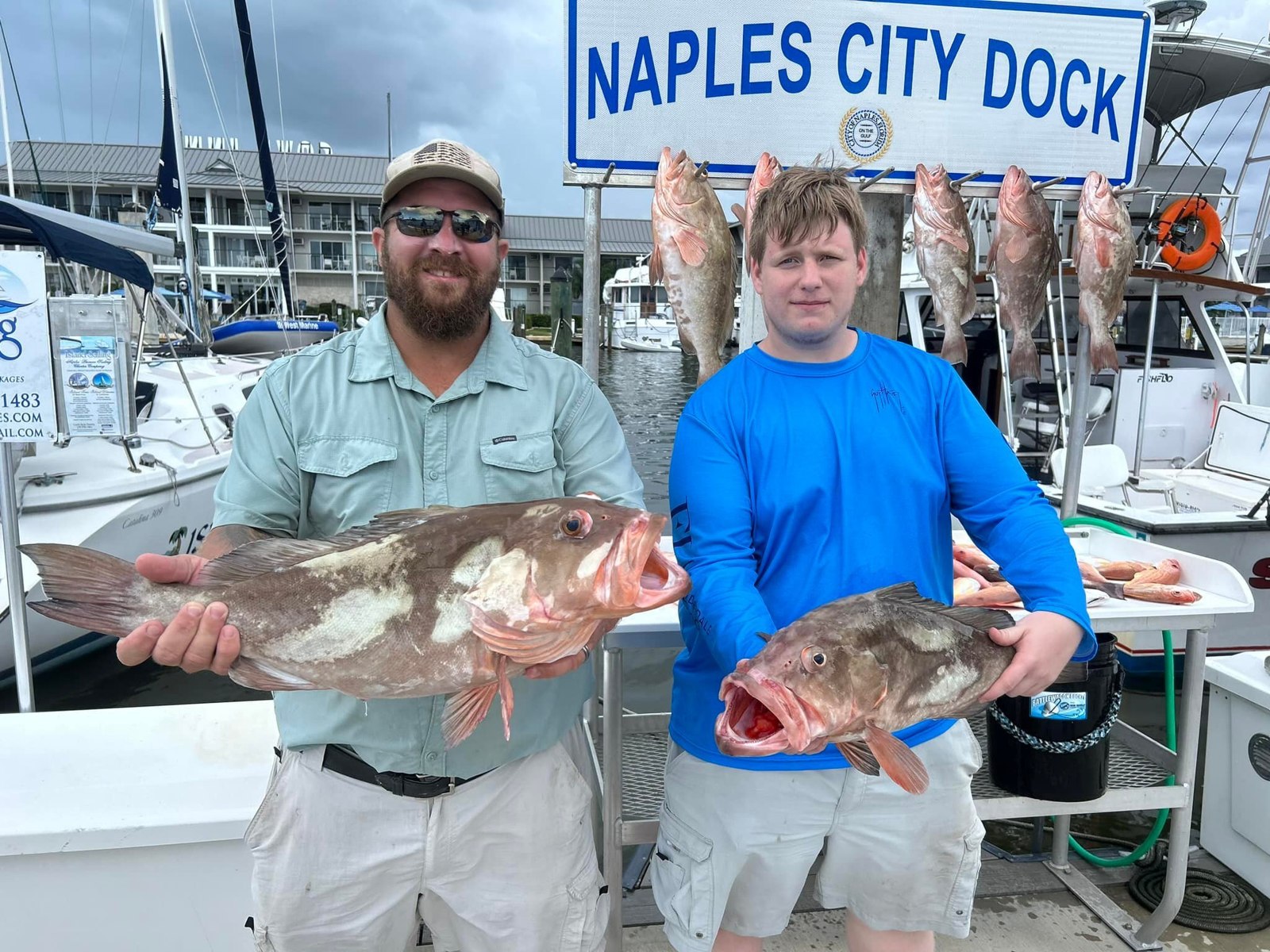 FishFlo Sea Legs Charters adult and young angler holding a grouper
