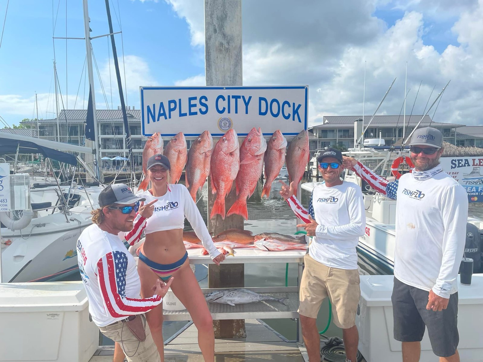 FishFlo Sea Legs Charters guests displaying their catch at Naples City Dock