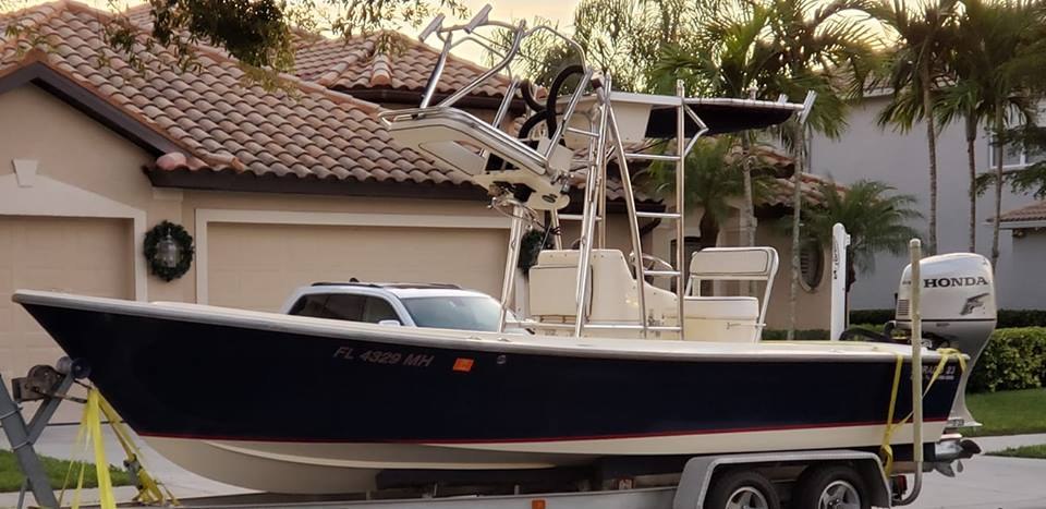 FishyBizness Charters blue hulled center console boat on land