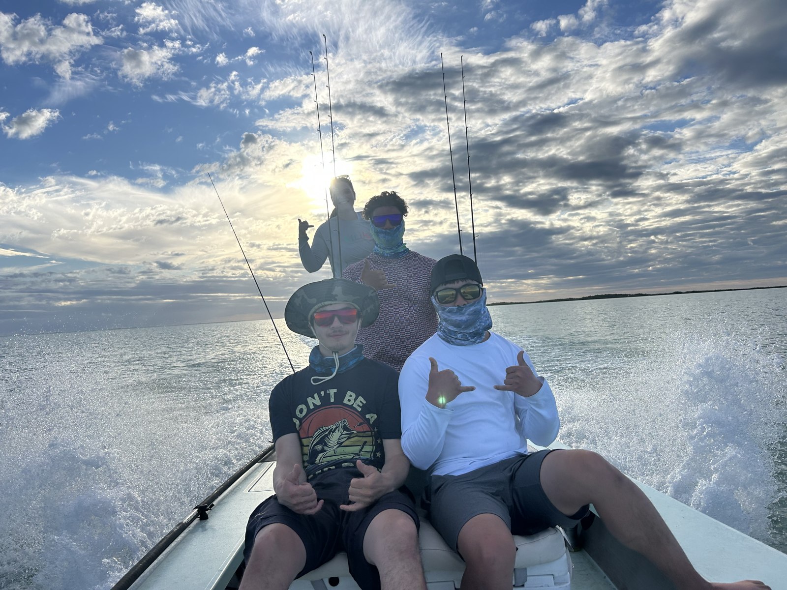 Guests riding aboard a skiff at sunset with Off-Ice Charters