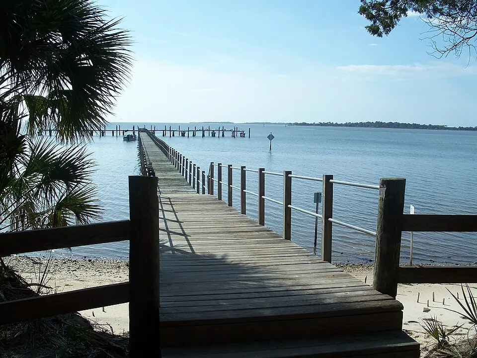 Wooden dock extending from Atsena Otie Key into coastal water