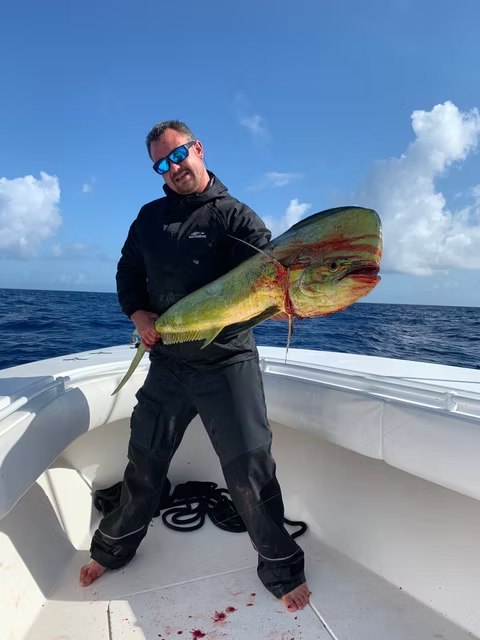 Heading West angler holding a mahi mahi