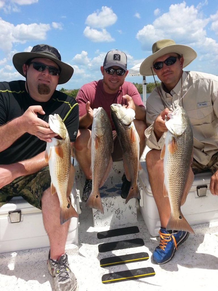 Homosassa Fishing Adventures guests holding their fish aboard the boat
