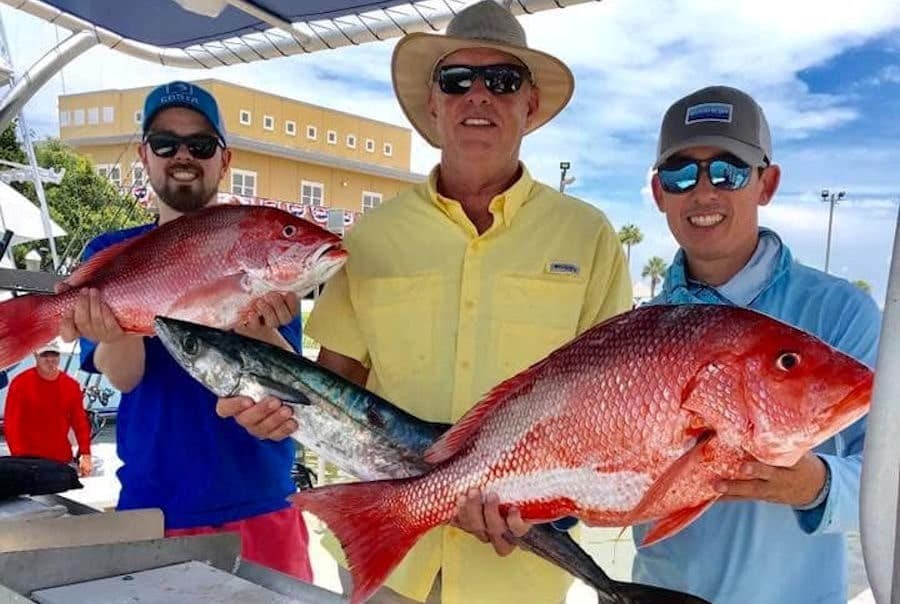 Anglers displaying redfish