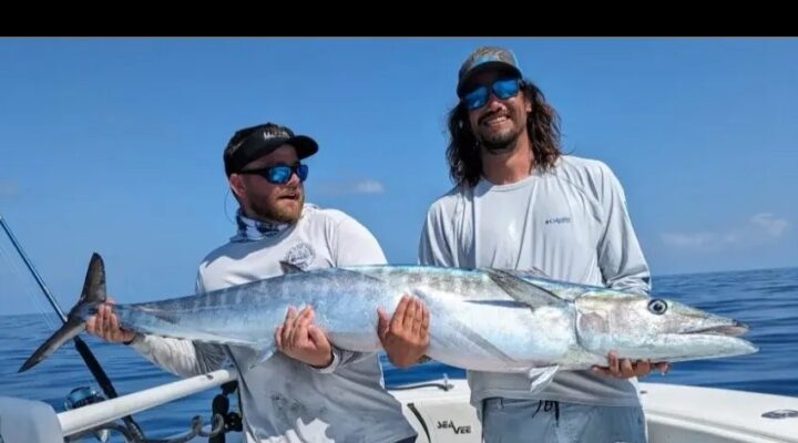 Most Excellent Fishing Charters two anglers displaying their catch aboard the boat