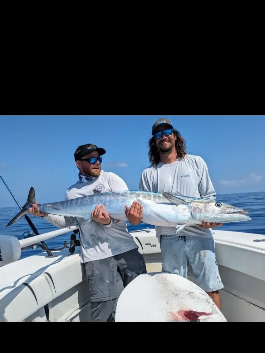 Most Excellent Fishing Charters two anglers displaying their catch aboard the boat