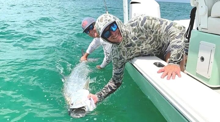 Nautical Souls angler handling a tarpon beside the boat