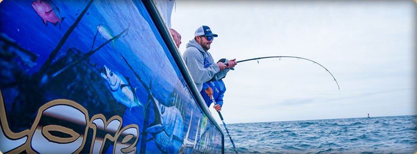 Offshore Hustler angler fighting a fish beside the boat