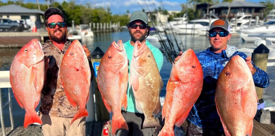Offshore Naples anglers holding red snapper