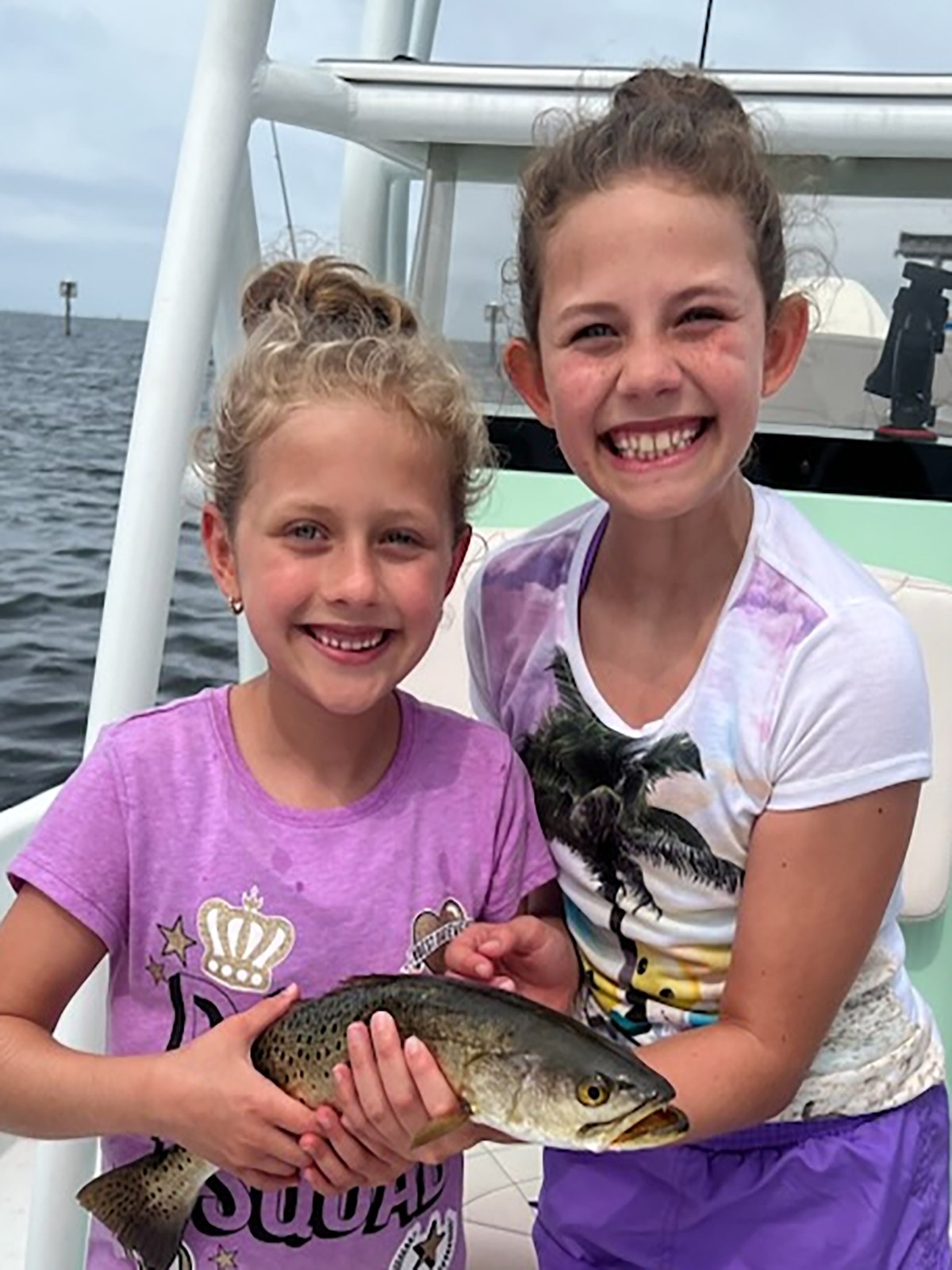 Young anglers holding a fish
