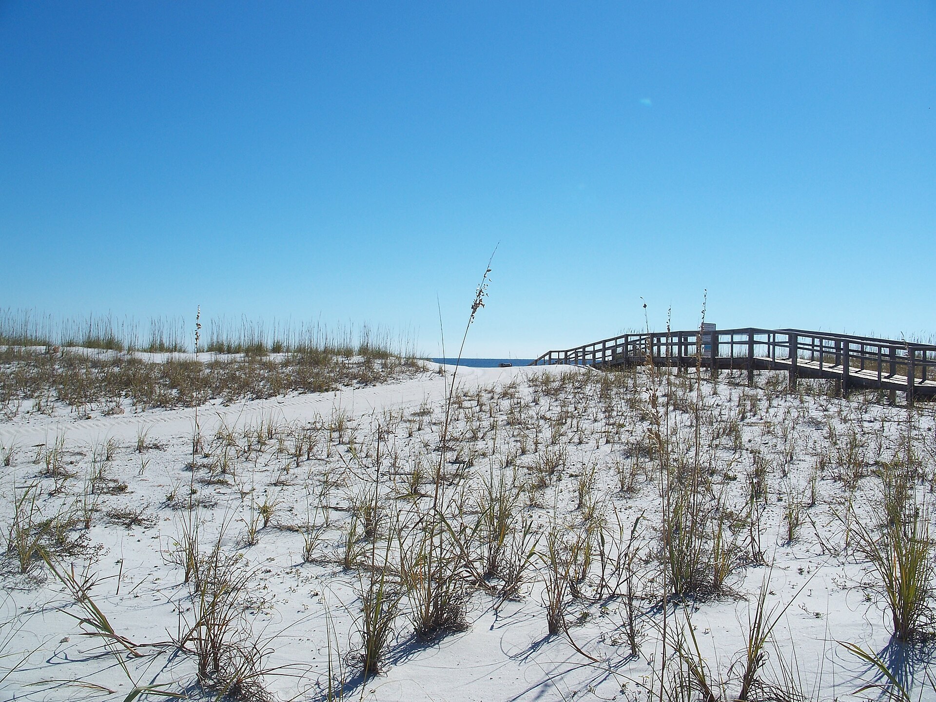 Wooden beach walkover crossing white dunes at Pensacola Beach