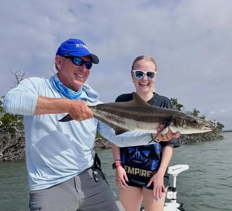 Pine Island Sportfishing young angler and captain displaying a snook