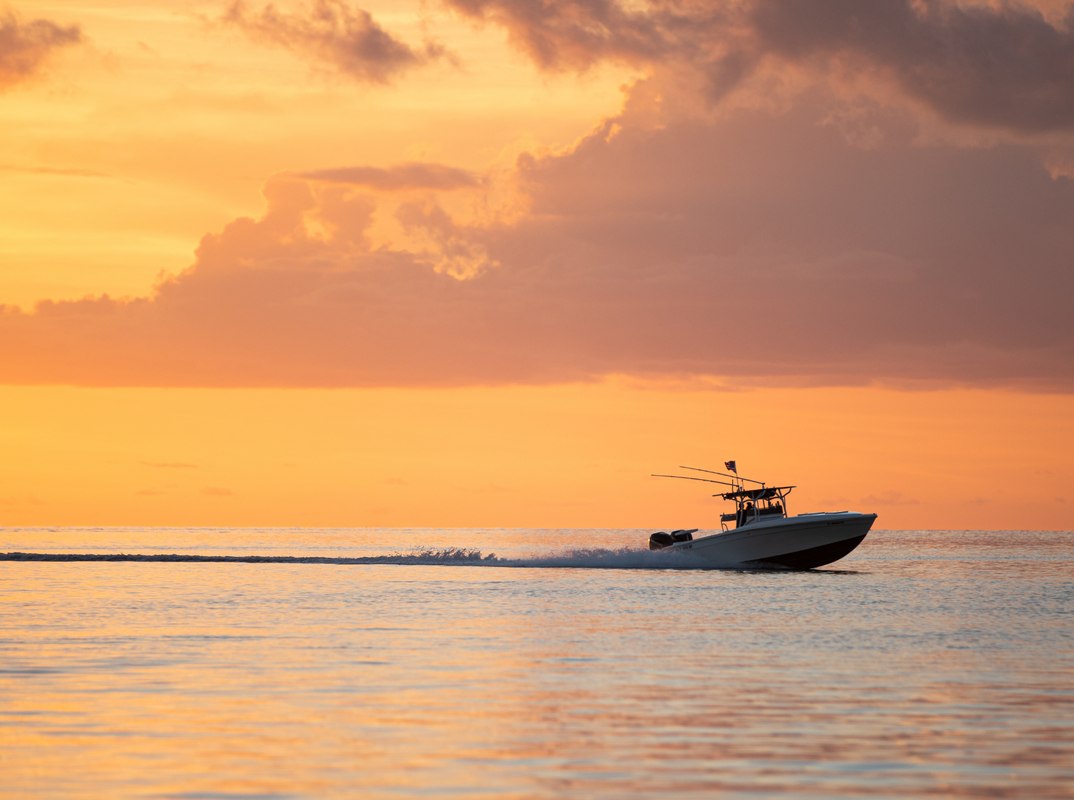 Salty Native Charters charter boat underway at sunset
