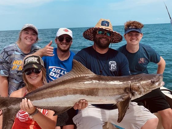 Smokin' Hooks Charters group displaying a cobia